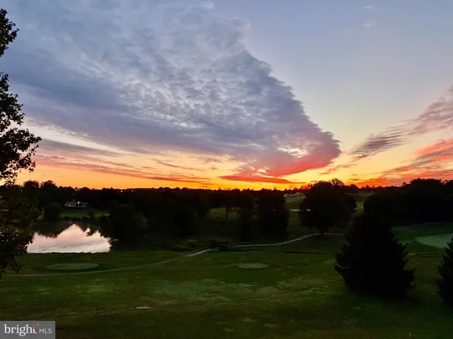 a white building with glass table and chairs