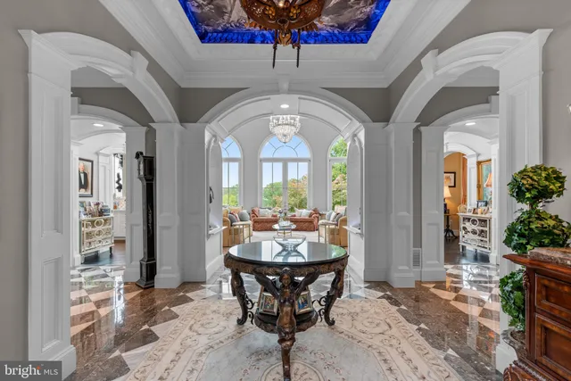 a living room with fireplace furniture and a large window