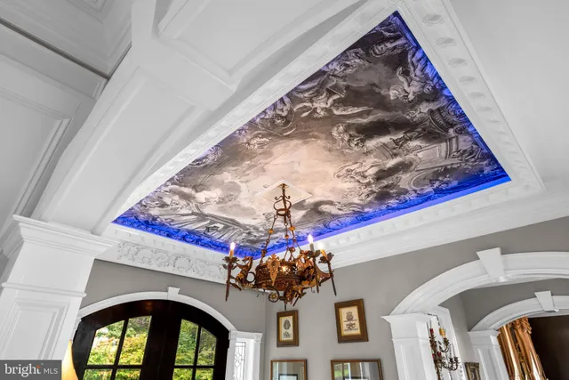 a living room with patio furniture and a large window