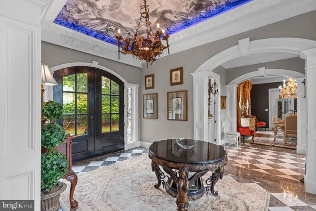 a living room with fireplace furniture and a large window