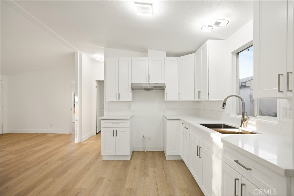 10350 Base Line Road, Unit 128 Rancho Cucamonga, CA 91701 - Photo 11 of 24 a kitchen with stainless steel appliances granite countertop refrigerator sink and cabinets