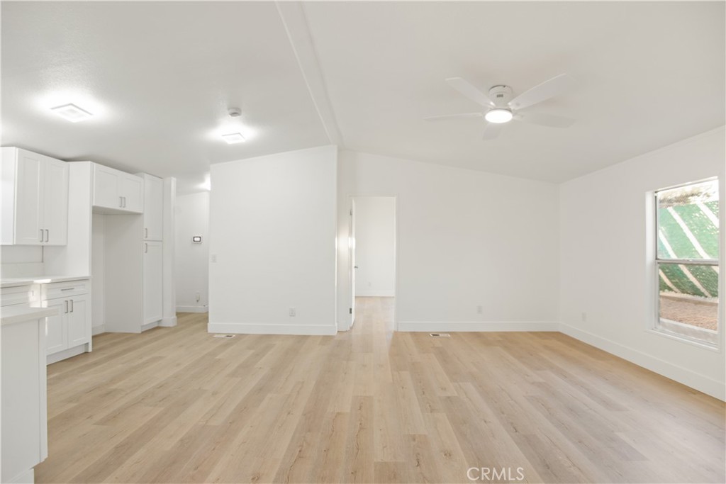 10350 Base Line Road, Unit 128 Rancho Cucamonga, CA 91701 - Photo 14 of 24 an empty room with wooden floor and windows