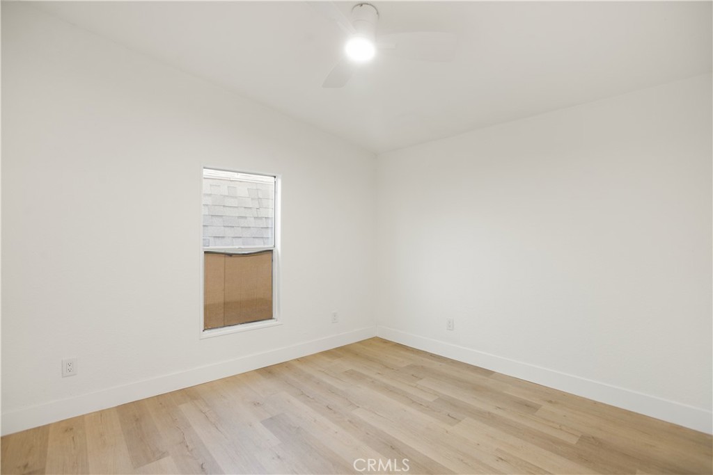 10350 Base Line Road, Unit 128 Rancho Cucamonga, CA 91701 - Photo 16 of 24 an empty room with wooden floor and windows