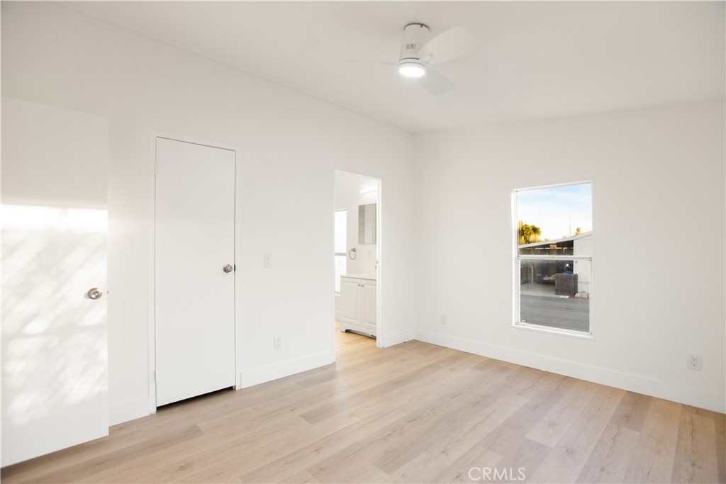 10350 Base Line Road, Unit 128 Rancho Cucamonga, CA 91701 - Photo 21 of 24 an empty room with wooden floor and windows