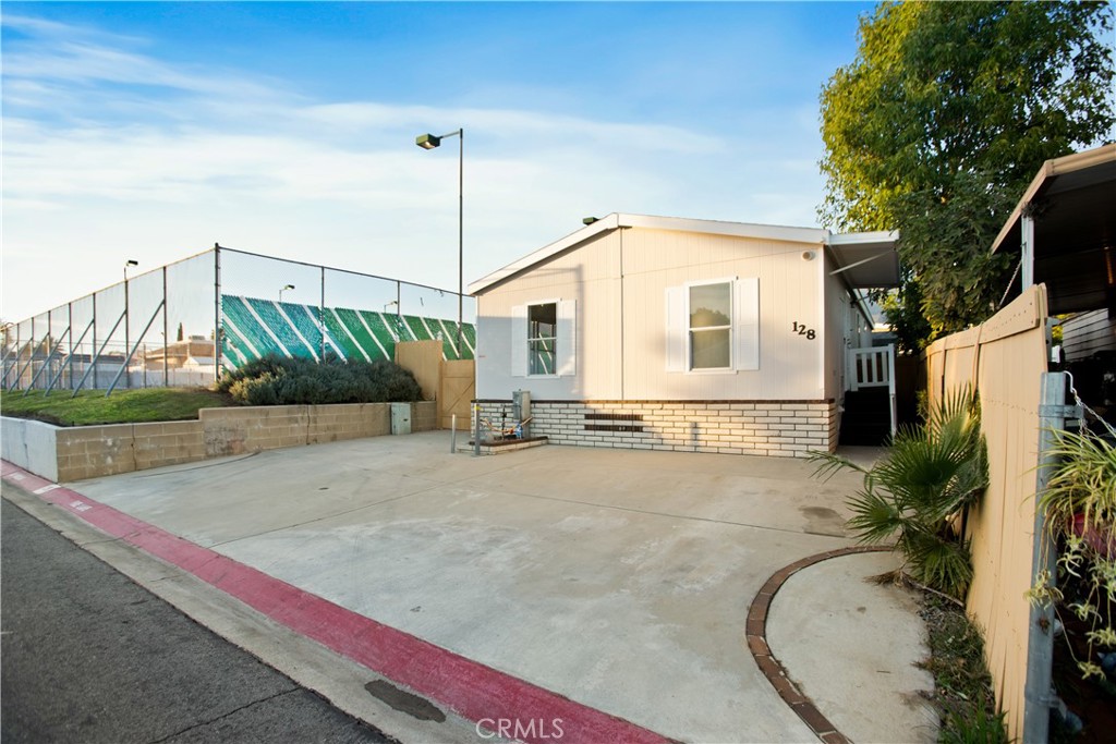 10350 Base Line Road, Unit 128 Rancho Cucamonga, CA 91701 - Photo 3 of 24 a front view of a house with a yard