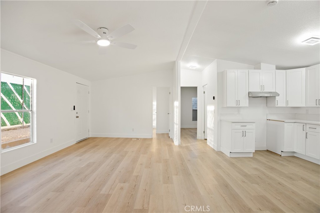 10350 Base Line Road, Unit 128 Rancho Cucamonga, CA 91701 - Photo 8 of 24 a view of a kitchen with wooden floor and windows