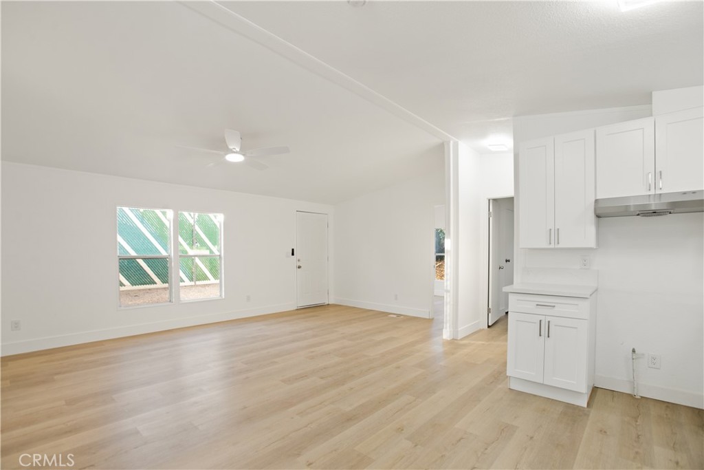 10350 Base Line Road, Unit 128 Rancho Cucamonga, CA 91701 - Photo 10 of 24 an empty room with wooden floor and window