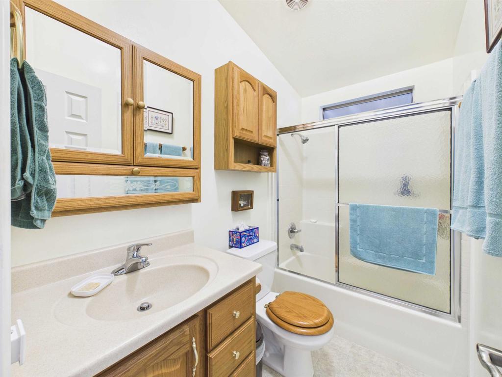 18218 Paradise Mountain Road, Unit 220 Valley Center, CA 92082 - Photo 36 of 48 a bathroom with a sink a toilet and a shower