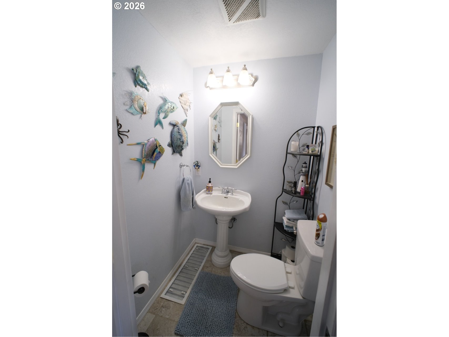 70214 Lakewood Road North Bend, OR 97459 - Photo 15 of 39 a bathroom with a toilet sink and mirror