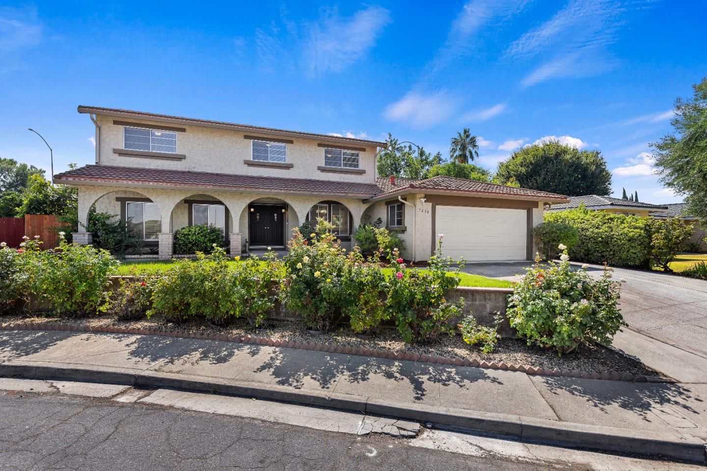 front view of a house with a garden