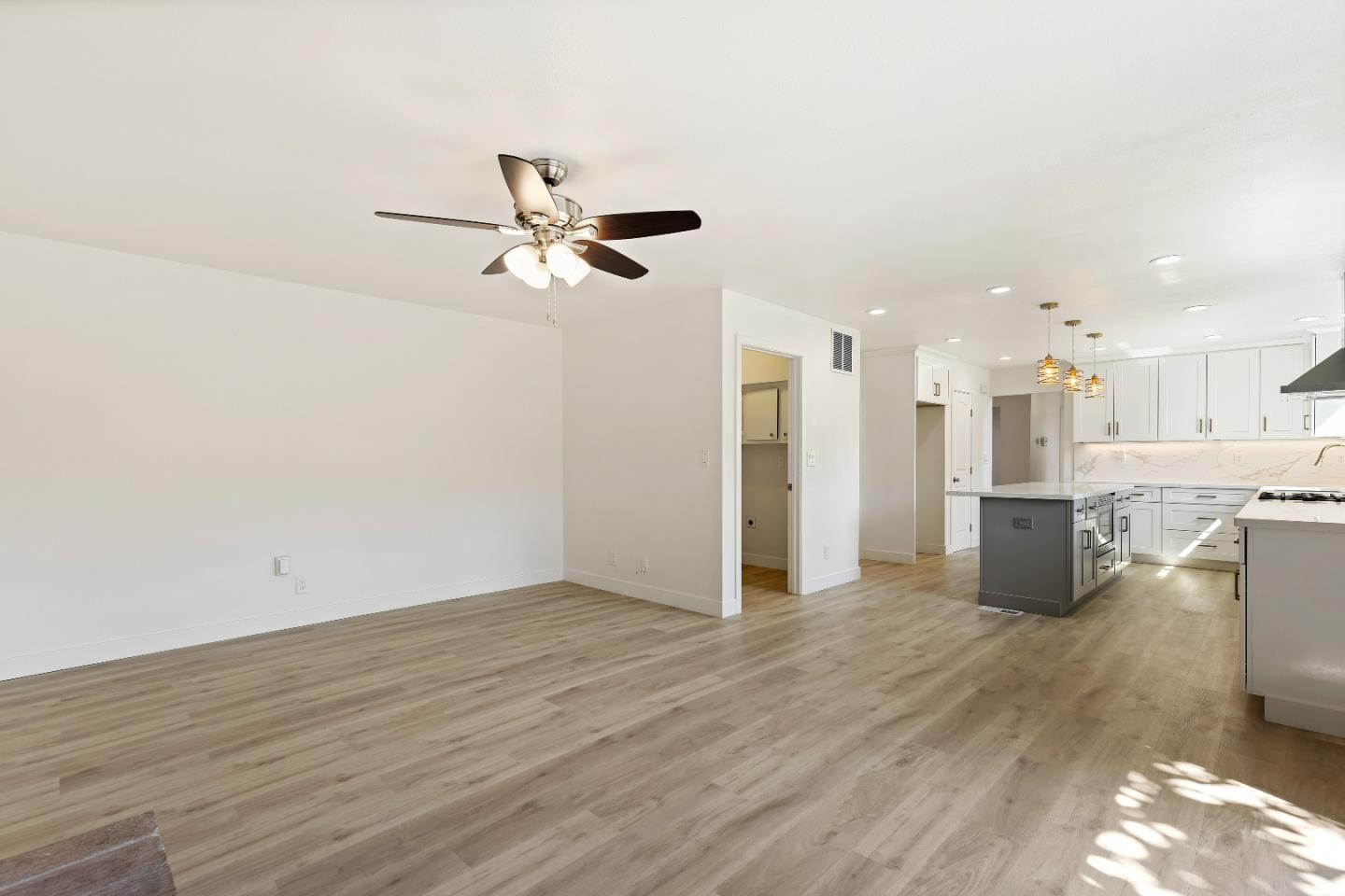 1238 Steven Drive Pittsburg, CA 94565 - Photo 22 of 39 a view of a big room with wooden floor and a kitchen