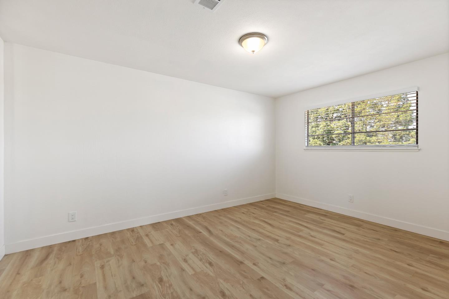 1238 Steven Drive Pittsburg, CA 94565 - Photo 27 of 39 an empty room with wooden floor and windows