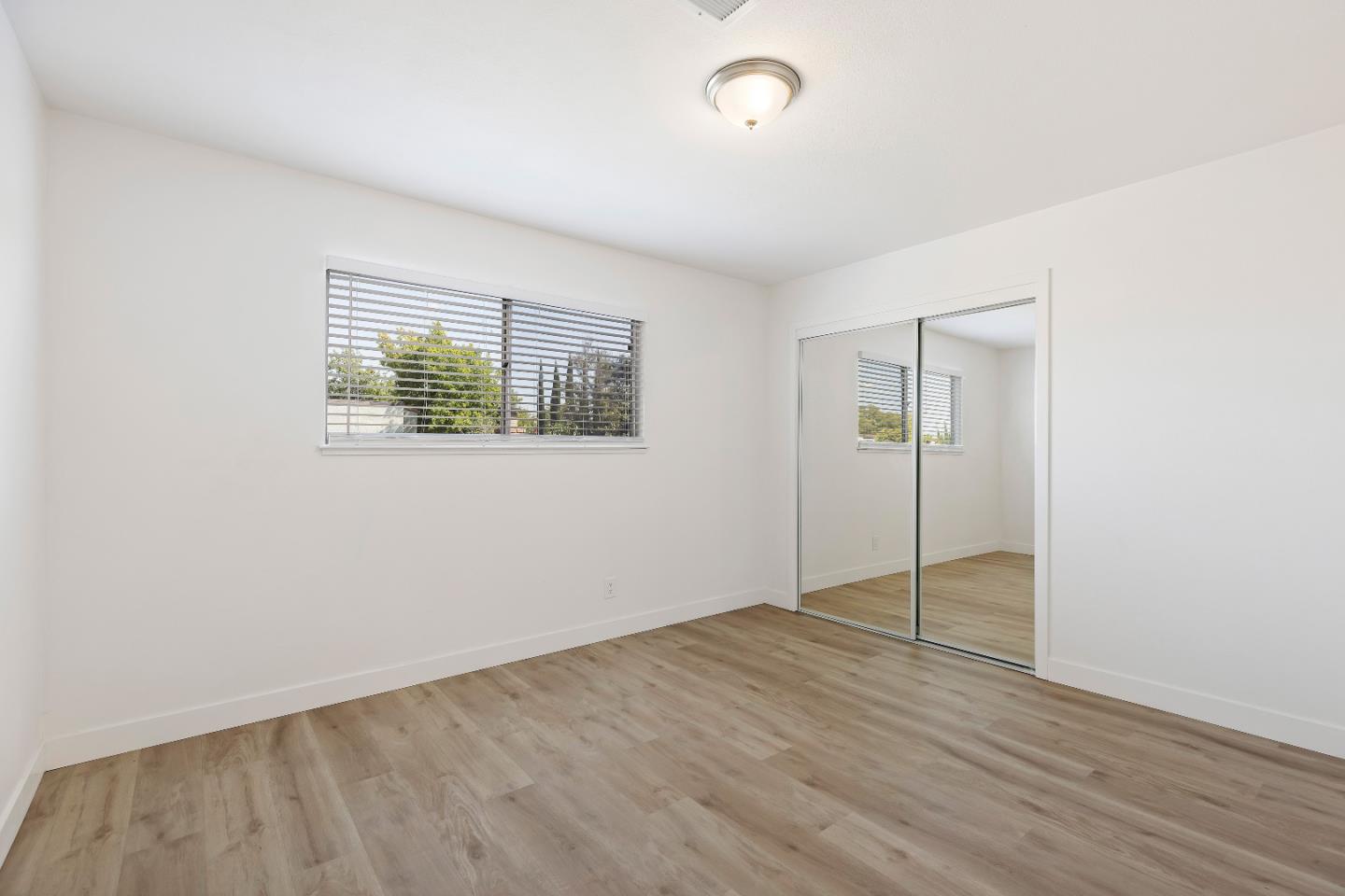 1238 Steven Drive Pittsburg, CA 94565 - Photo 33 of 39 an empty room with wooden floor closet and windows