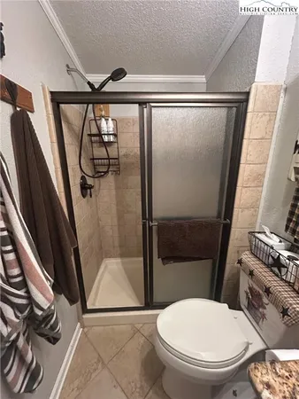 a bathroom with a toilet and a shower