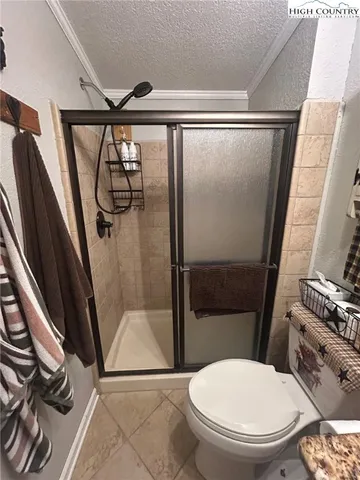 a bathroom with a toilet and a shower