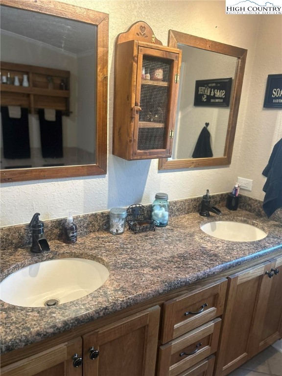 480 Fraser Road Sparta, NC 28675 - Photo 25 of 36 a bathroom with a granite countertop sink and a mirror