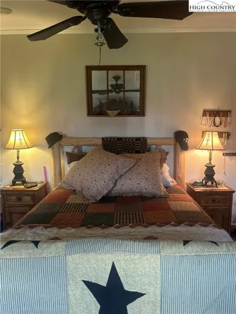 a bedroom with a bed and painting on the wall