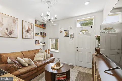 a living room with furniture and a chandelier