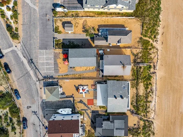 a kitchen with stainless steel appliances granite countertop a stove a sink a dining table and chairs with wooden floor