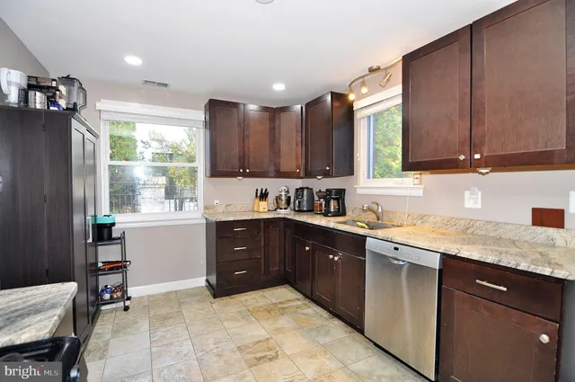 a kitchen with a refrigerator stove and cabinets