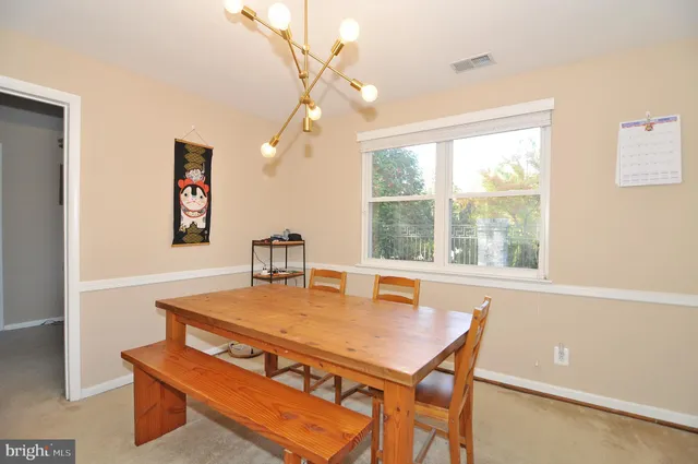 a living room with furniture a window and a flat screen tv