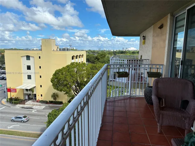 a view of a balcony with wooden floor and city view