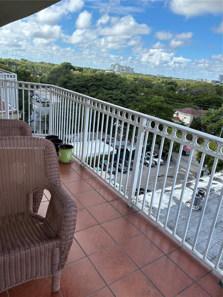 1650 Coral Way, Unit 808 Miami, FL 33145 - Photo 13 of 29 a view of a balcony with wooden floor and city view