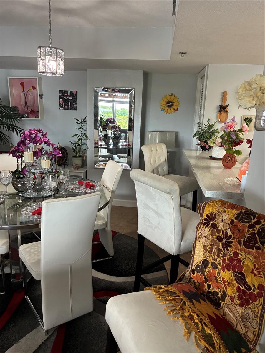 1650 Coral Way, Unit 808 Miami, FL 33145 - Photo 19 of 29 a living room with furniture and a chandelier