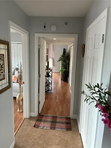 a view of hallway with furniture and stairs