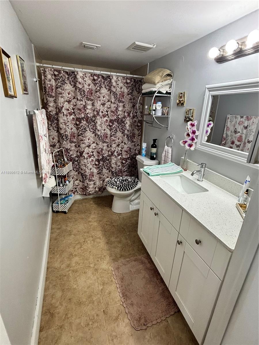1650 Coral Way, Unit 808 Miami, FL 33145 - Photo 28 of 29 a bathroom with a sink mirror and vanity