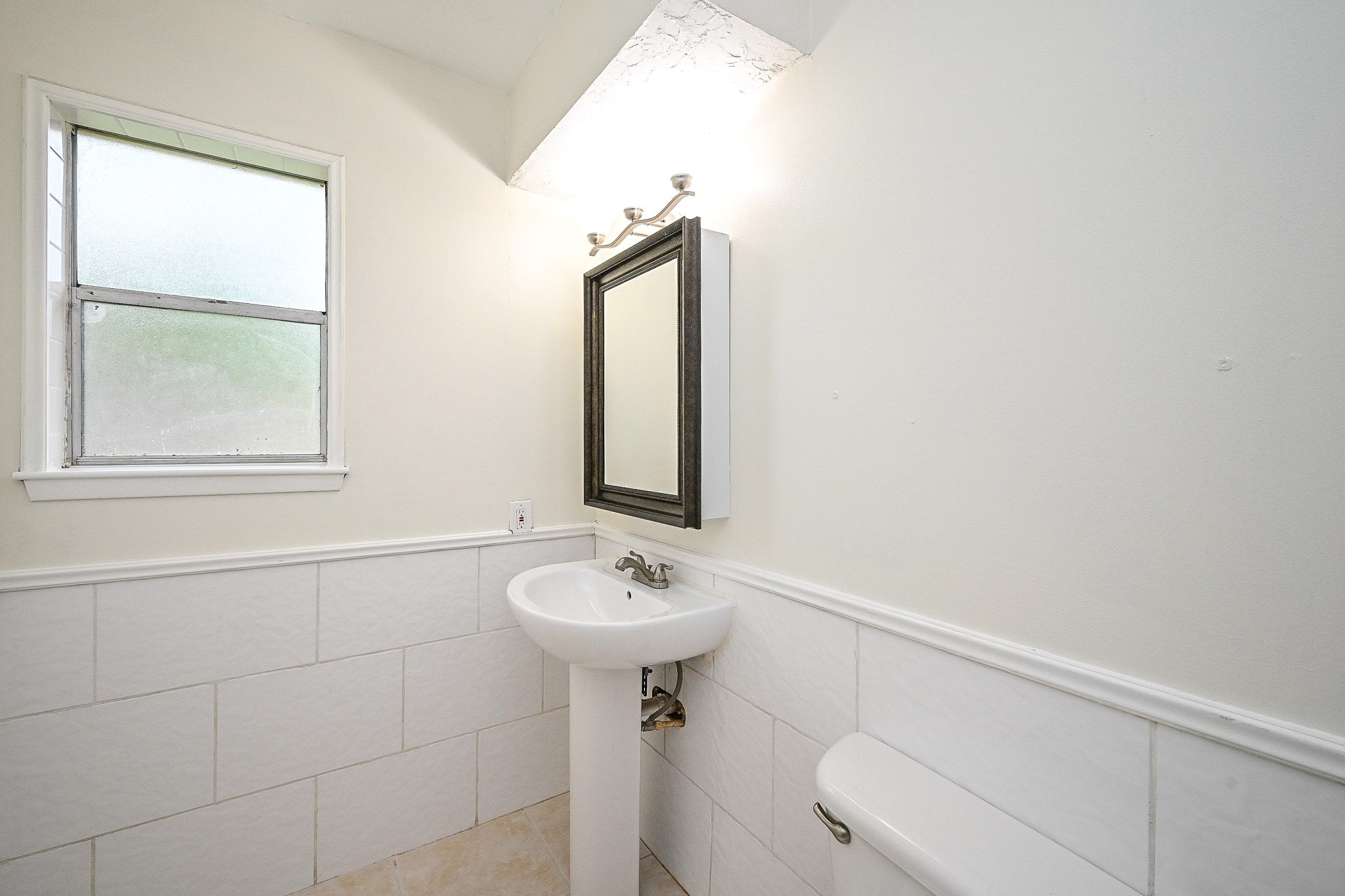 23814 Spring Gum Drive Spring, TX 77373 - Photo 19 of 21 a bathroom with a sink mirror and toilet
