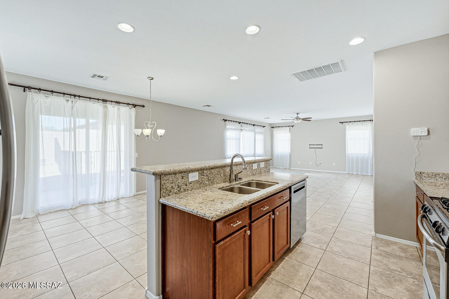 323 East Refuge Loop Vail, AZ 85641 - Photo 13 of 51 a kitchen with a counter top a sink a refrigerator and window