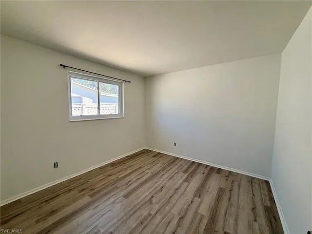 a bathroom with a granite countertop sink toilet a mirror and shower