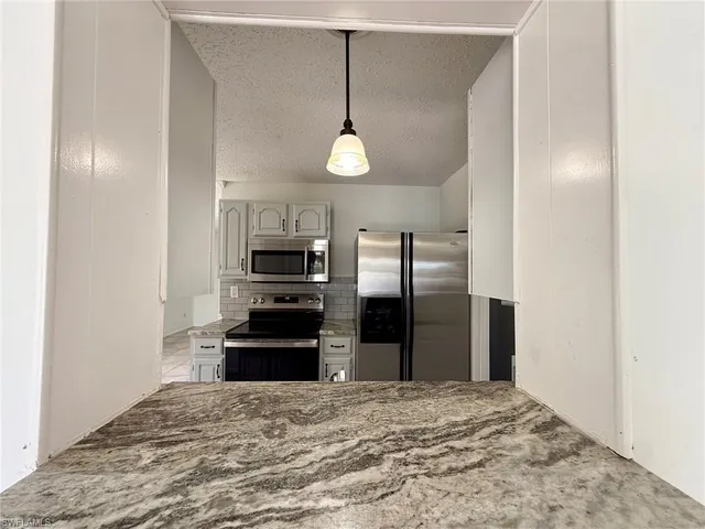 a view of a livingroom with a ceiling fan and window