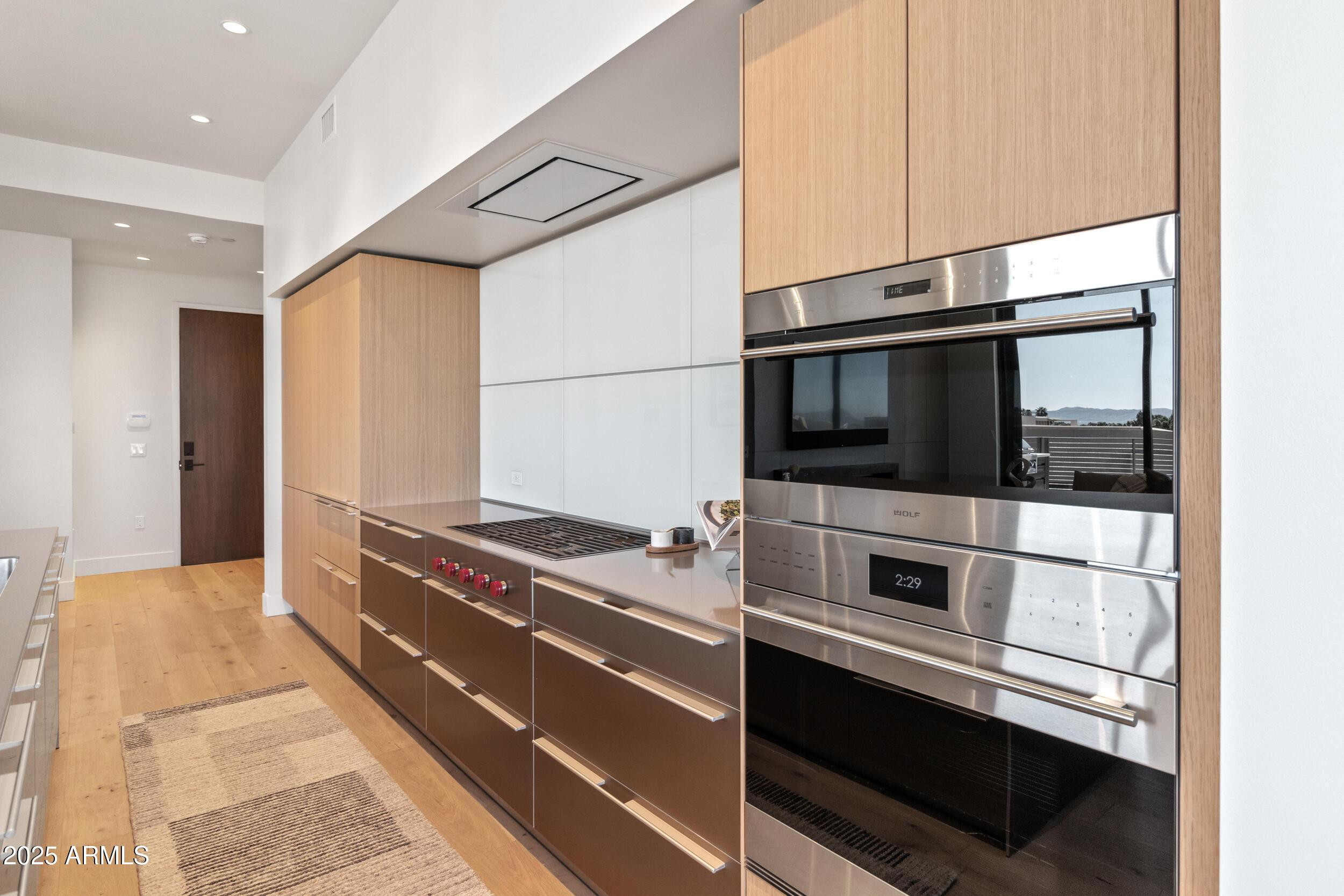 5000 North Camelback Ridge Drive, Unit 302 Scottsdale, AZ 85251 - Photo 12 of 42 a kitchen with stainless steel appliances and cabinets