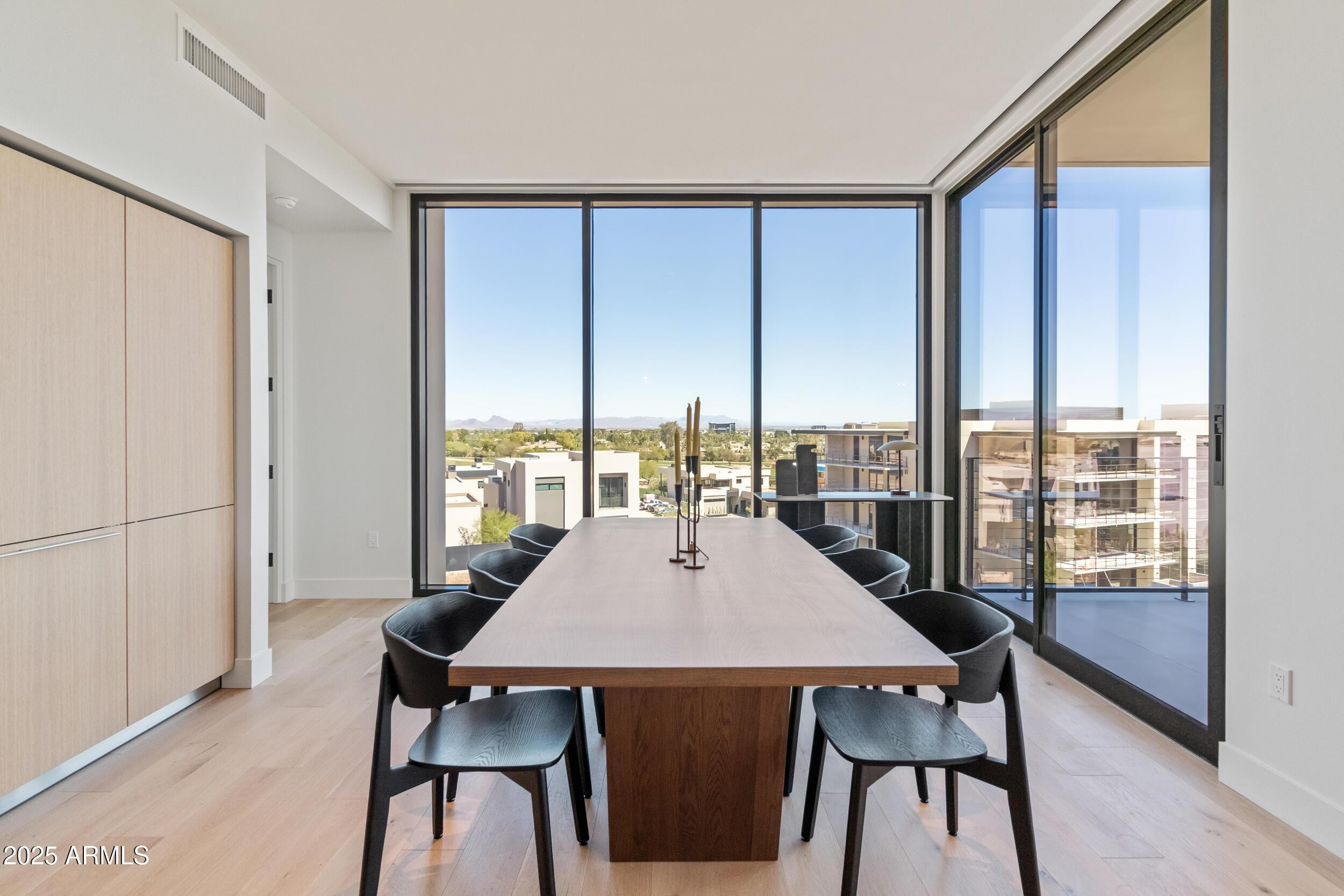 5000 North Camelback Ridge Drive, Unit 302 Scottsdale, AZ 85251 - Photo 13 of 42 a view of a dining room with furniture window and wooden floor