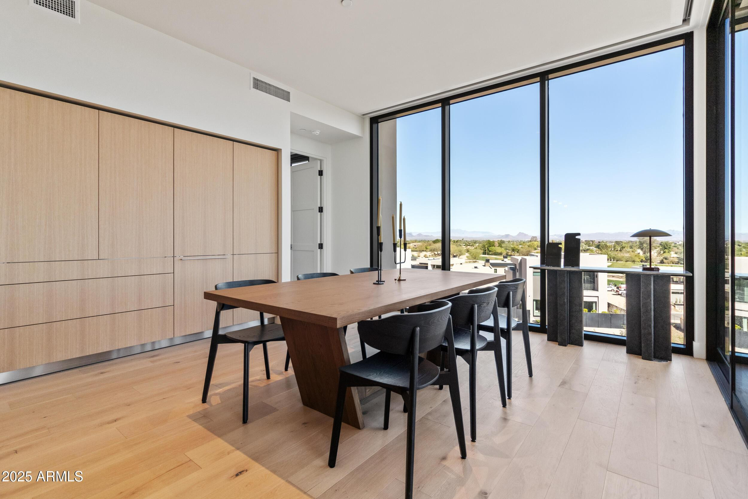 5000 North Camelback Ridge Drive, Unit 302 Scottsdale, AZ 85251 - Photo 14 of 42 a view of a dining room with furniture window and wooden floor