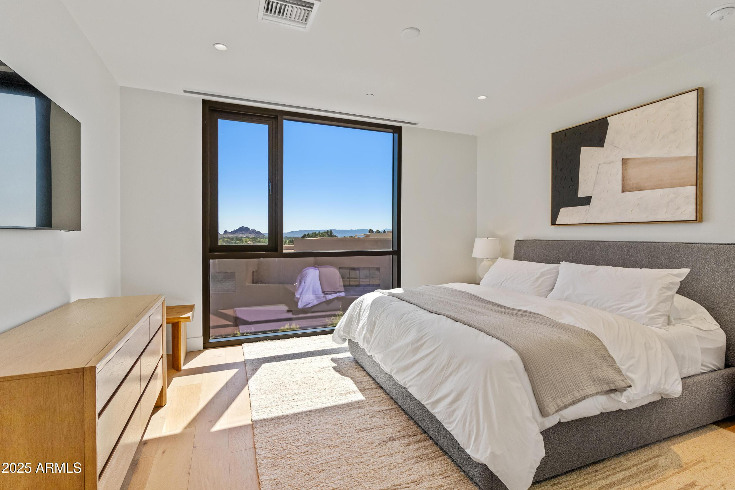 5000 North Camelback Ridge Drive, Unit 302 Scottsdale, AZ 85251 - Photo 25 of 42 a bedroom with a large bed and a large window
