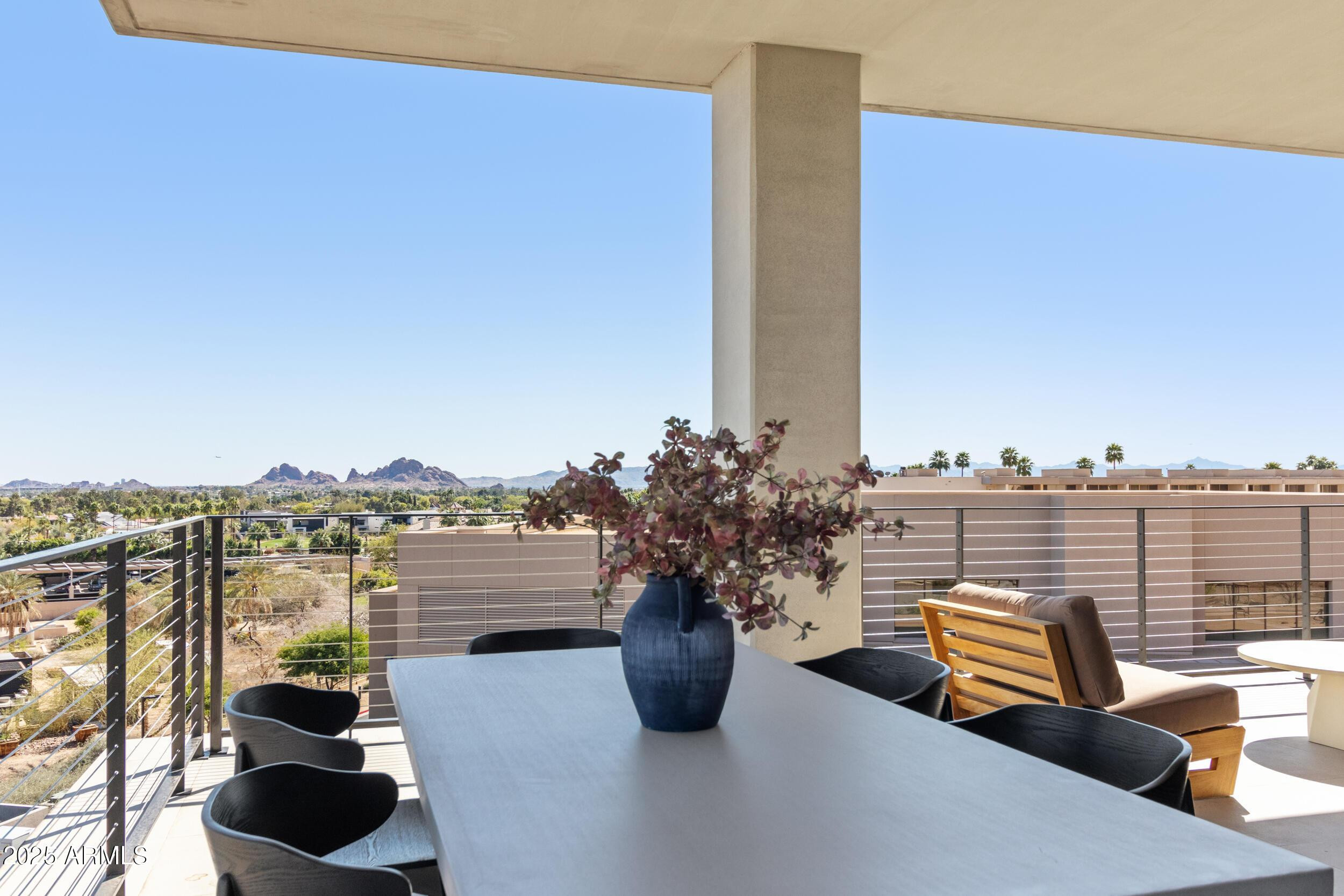 5000 North Camelback Ridge Drive, Unit 302 Scottsdale, AZ 85251 - Photo 33 of 42 a view of a balcony with two chairs and a potted plant