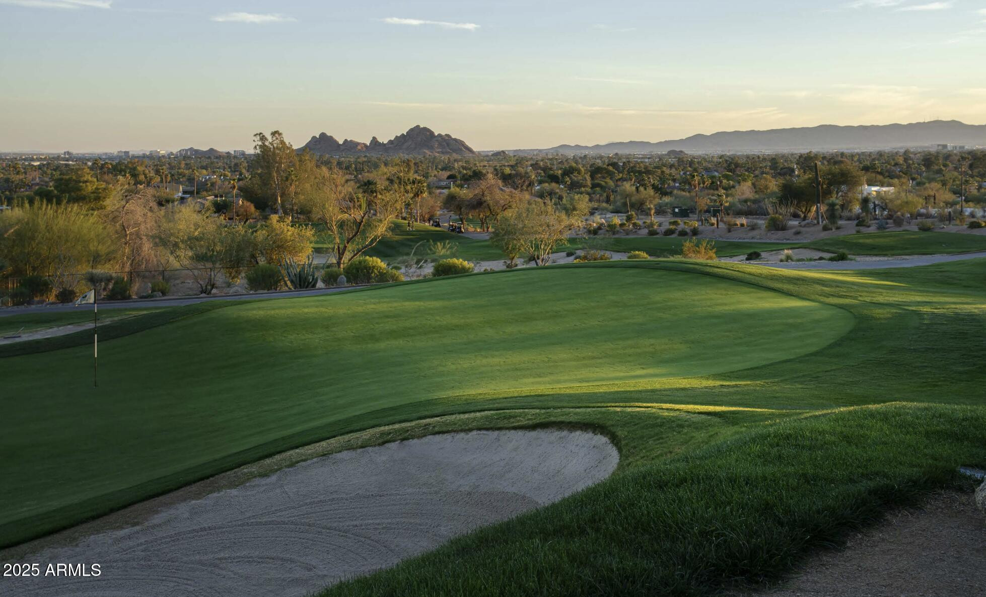5000 North Camelback Ridge Drive, Unit 302 Scottsdale, AZ 85251 - Photo 35 of 42 a view of a grassy field with mountains in the background