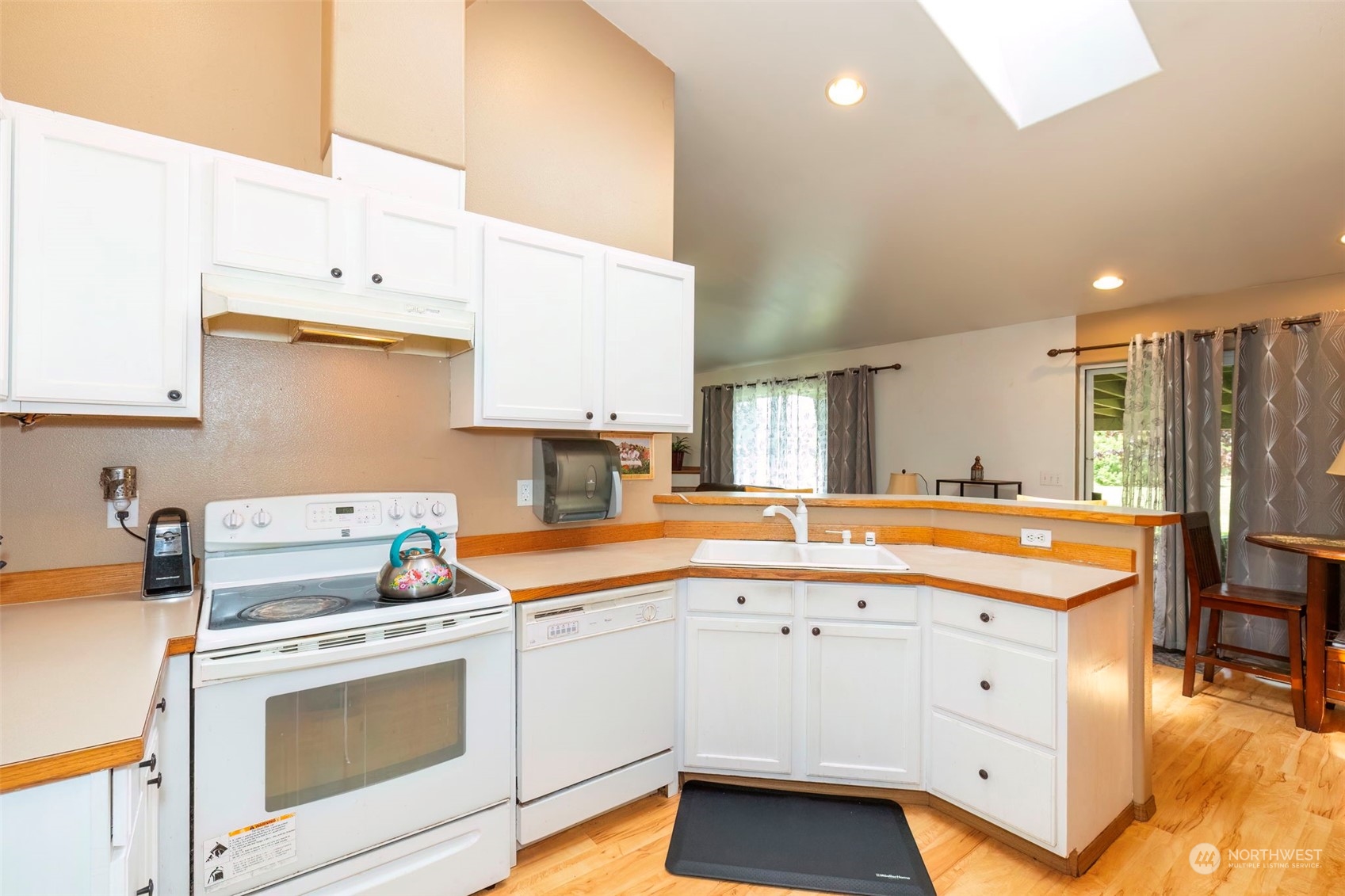 8222 178th Avenue Southwest Rochester, WA 98579 - Photo 11 of 36 a kitchen that has a lot of cabinets in it and wooden floors