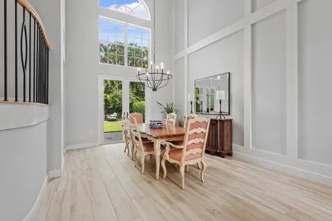 a dining room with furniture window and wooden floor
