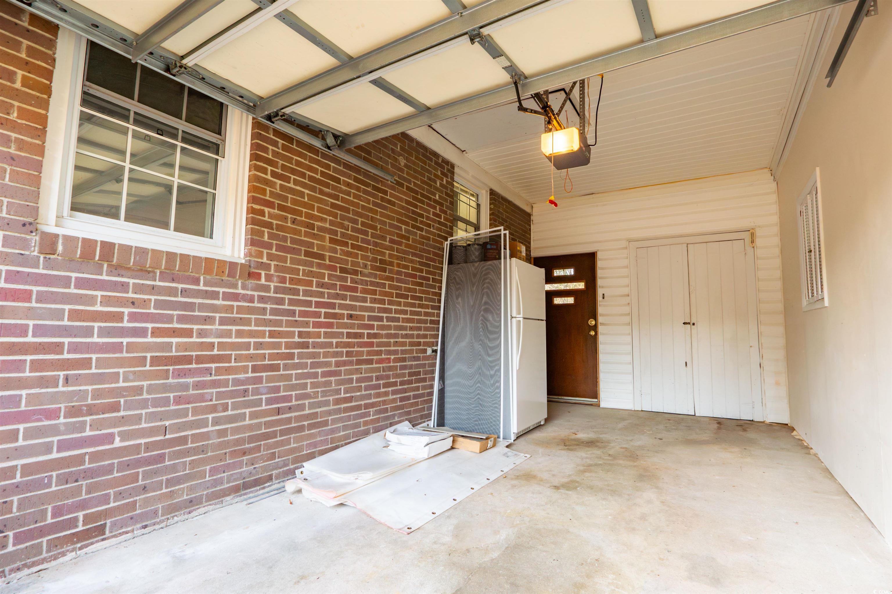 1105 Scott Drive Myrtle Beach, SC 29577 - Photo 13 of 13 Garage featuring a garage door opener