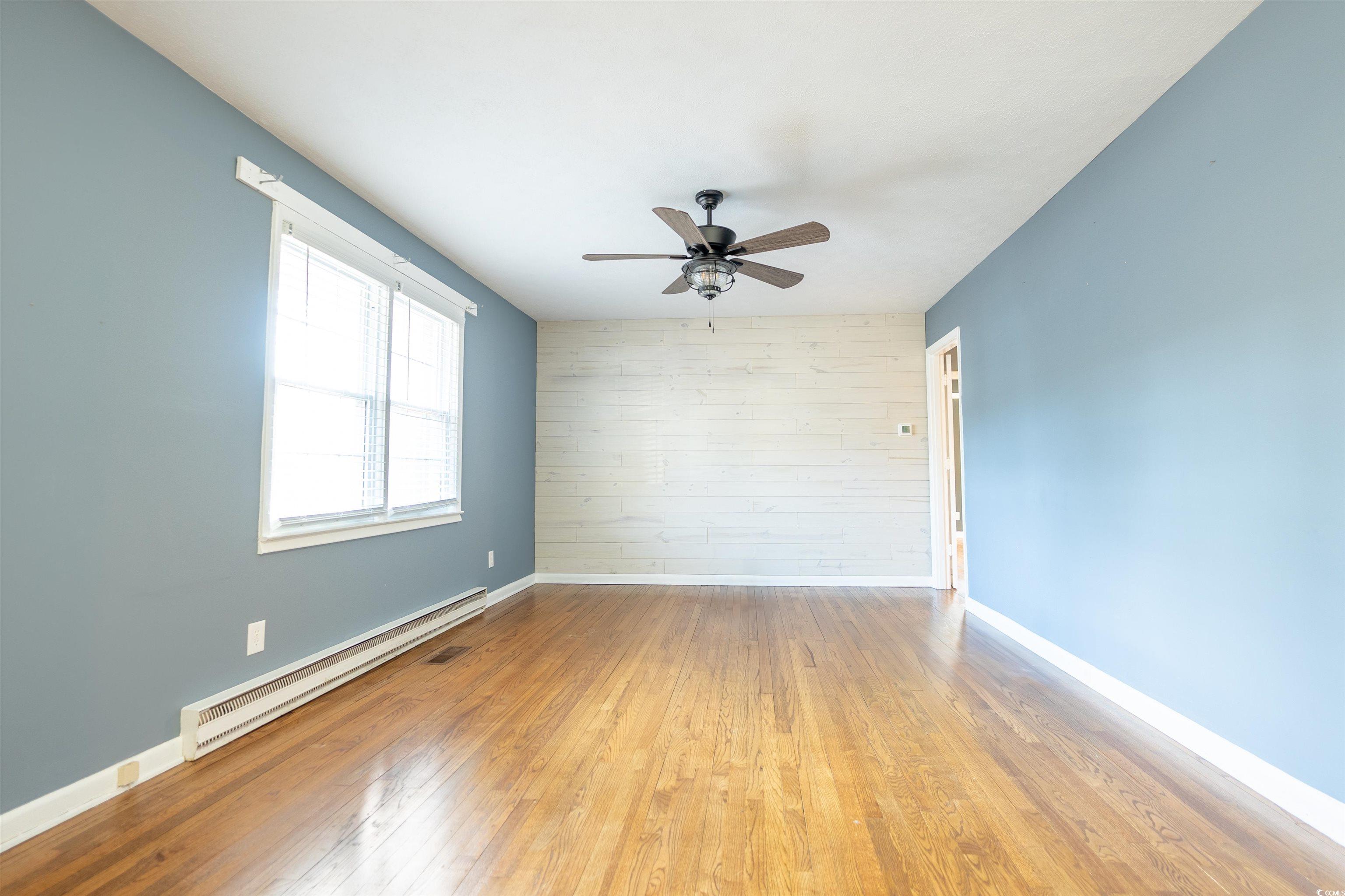 1105 Scott Drive Myrtle Beach, SC 29577 - Photo 3 of 13 Unfurnished room featuring ceiling fan, wood walls