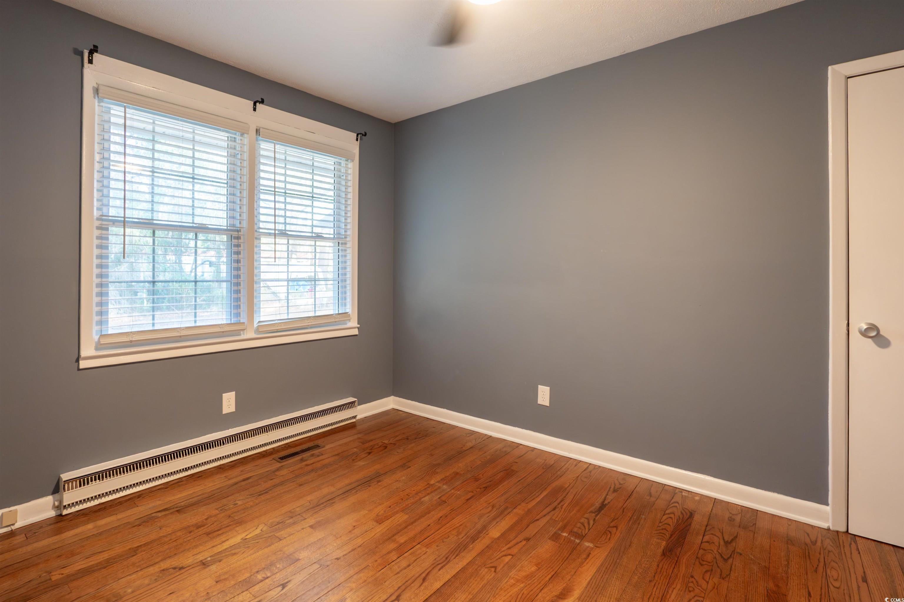 1105 Scott Drive Myrtle Beach, SC 29577 - Photo 6 of 13 Unfurnished room with hardwood / wood-style floors