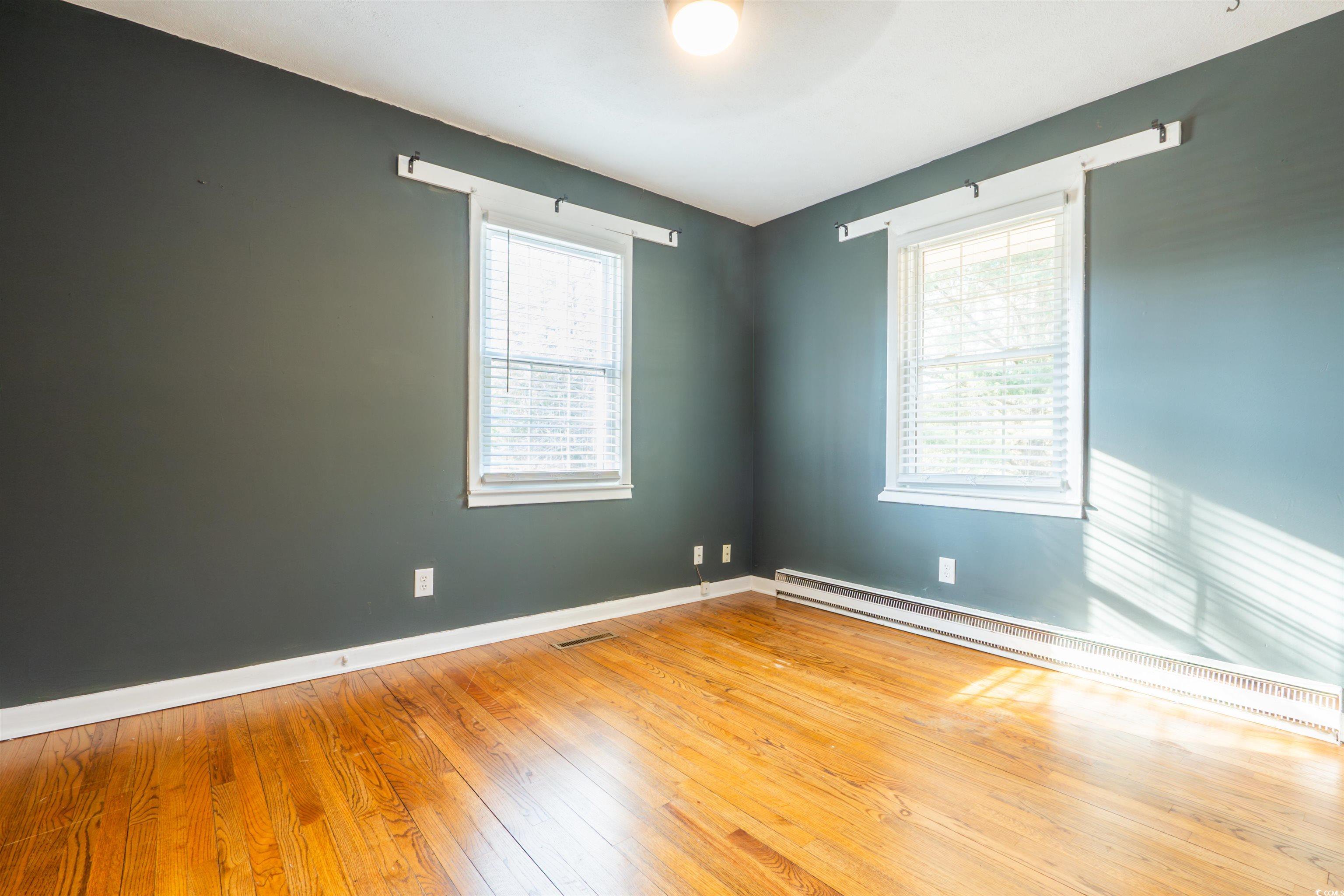 1105 Scott Drive Myrtle Beach, SC 29577 - Photo 7 of 13 Empty room featuring hardwood / wood-style floorin