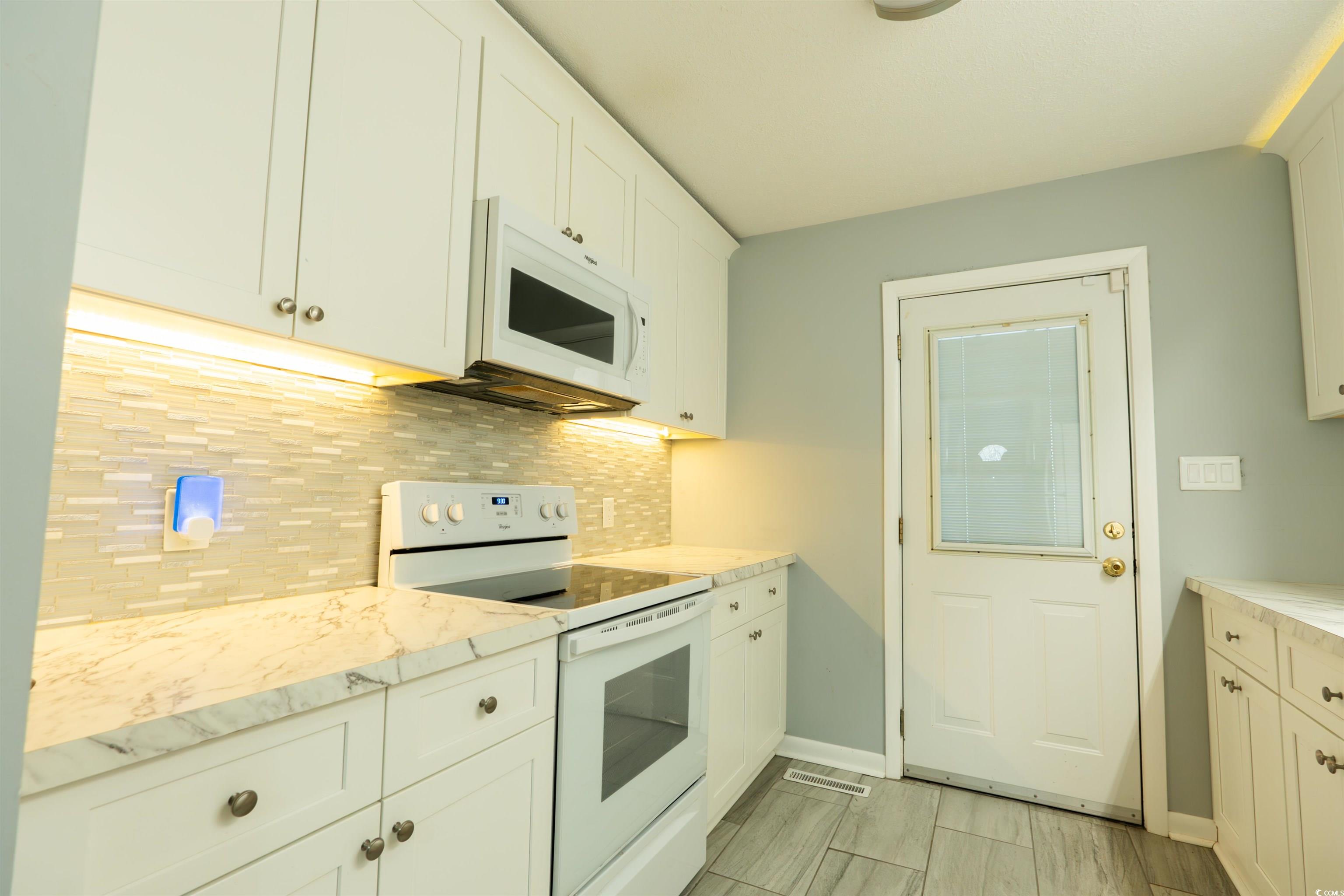 1105 Scott Drive Myrtle Beach, SC 29577 - Photo 9 of 13 Kitchen with white cabinetry, white appliances, ta