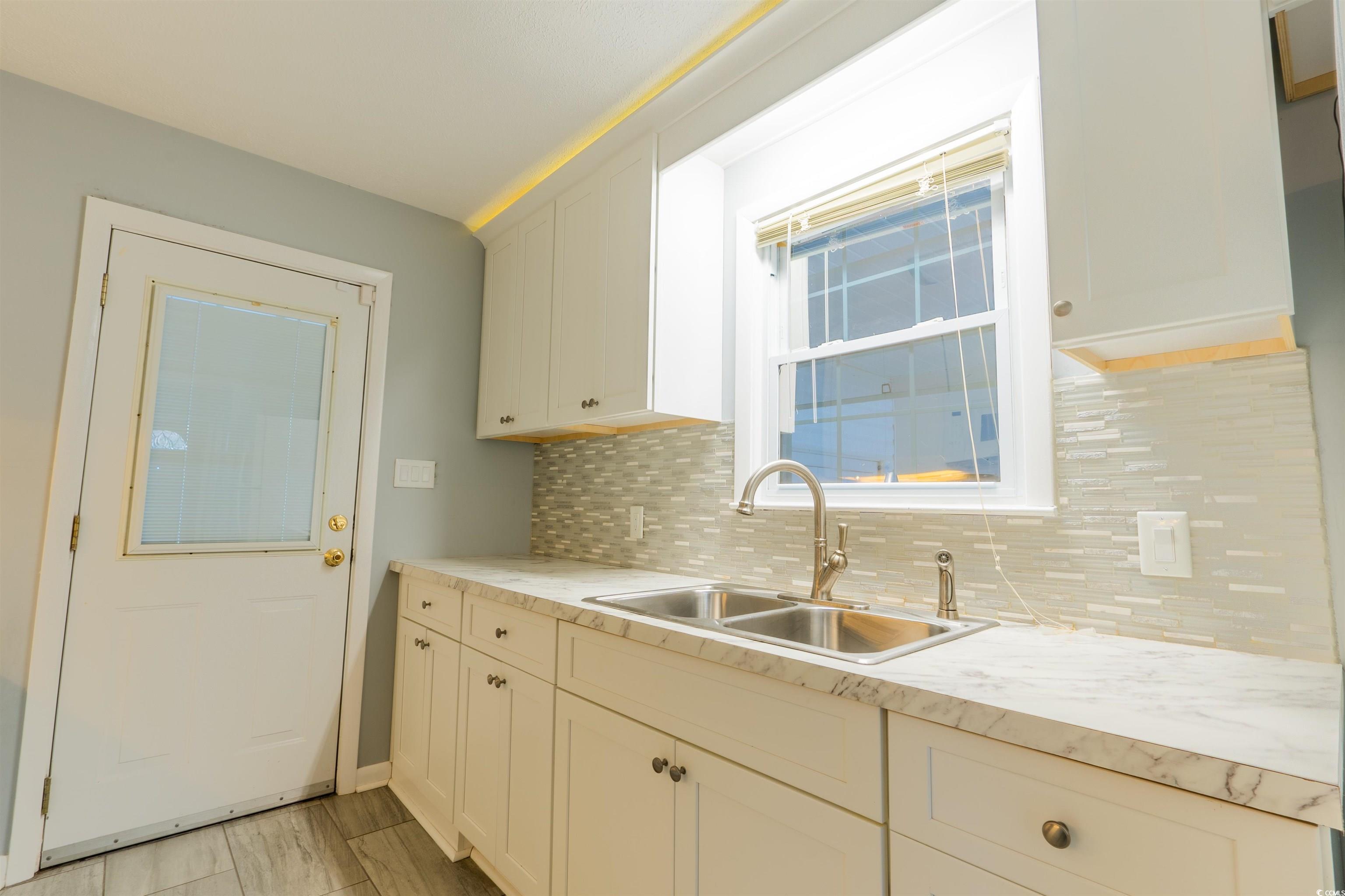 1105 Scott Drive Myrtle Beach, SC 29577 - Photo 10 of 13 Kitchen with tasteful backsplash, sink, and white