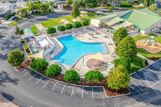 an aerial view of a house with garden space and lake view