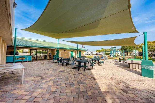 a view of a patio with table and chairs under an umbrella